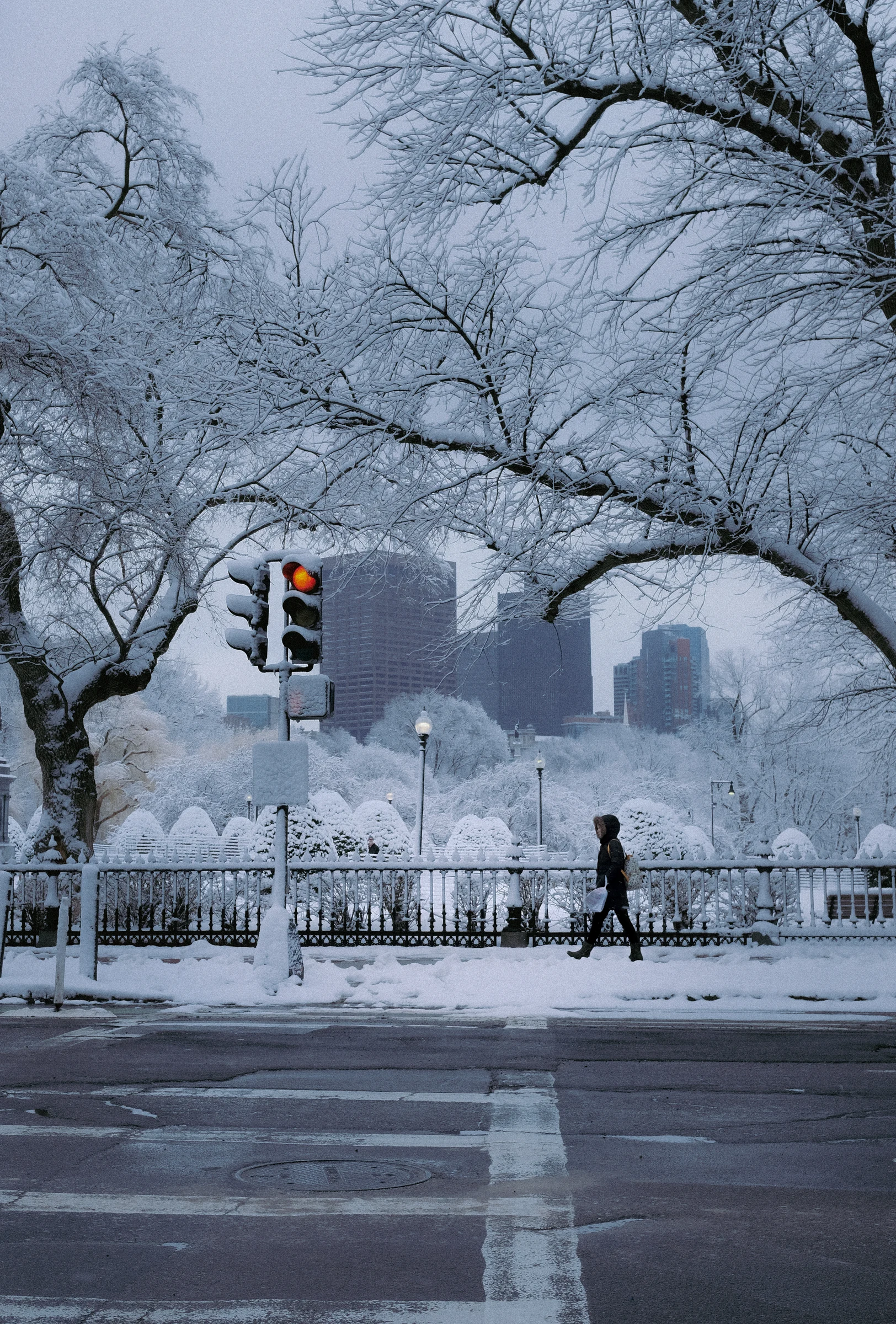 People walking through a snowy Boston street