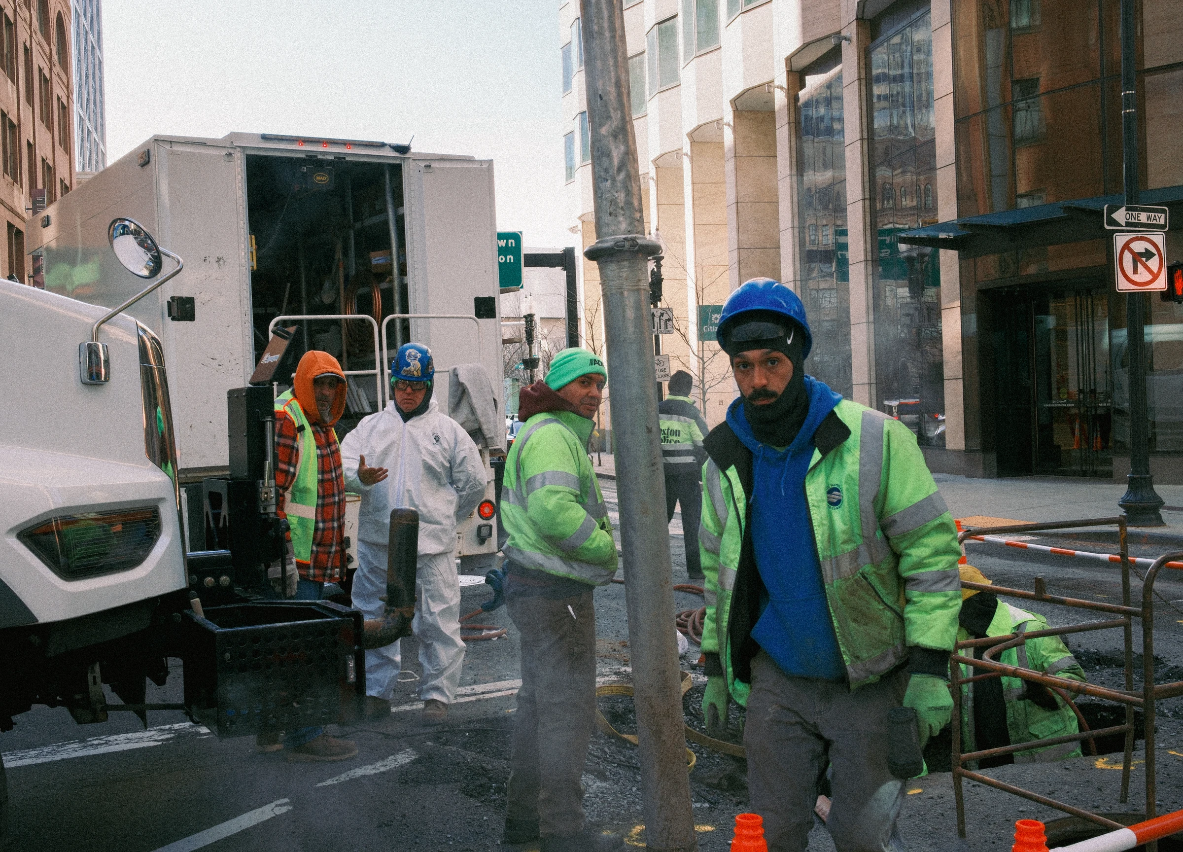 Four workers standing together on a Boston street